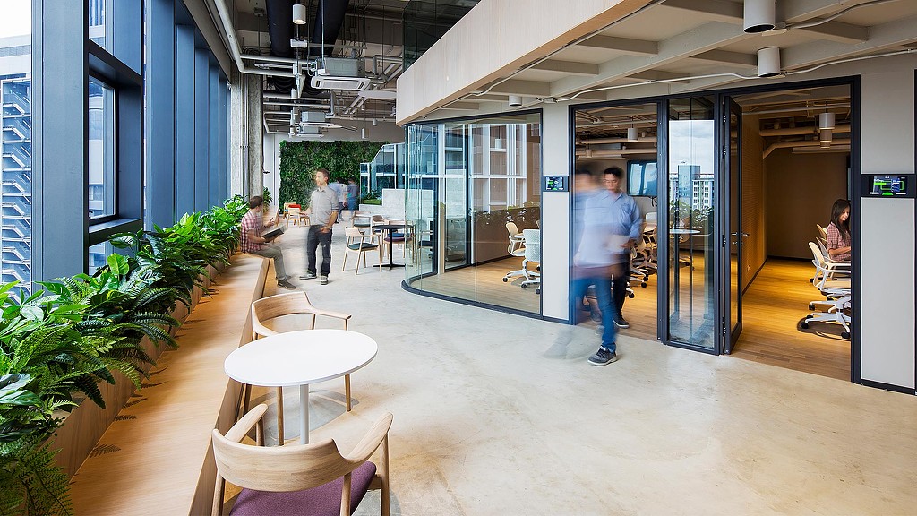 A group of people walking through a building.